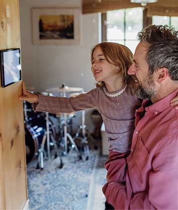 Father & daughter adjusting Wi-Fi thermostat